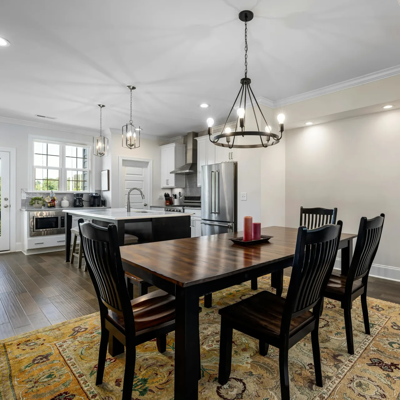An open concept kitchen and dining areas with a large wooden table