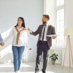 A property manager showing a young couple an apartment