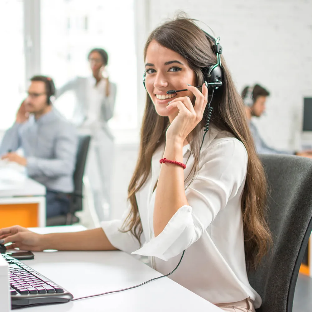 customer_service A smiling young woman answering the phone with a headset