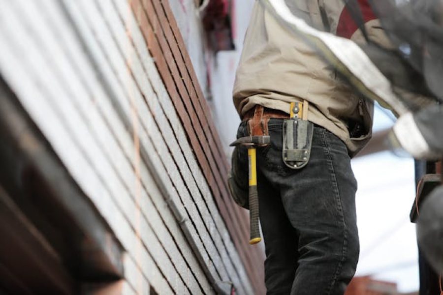 Person wearing a tool belt inspecting a home