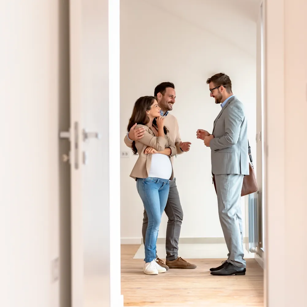 property_manager A man shows a couple around a vacant apartment