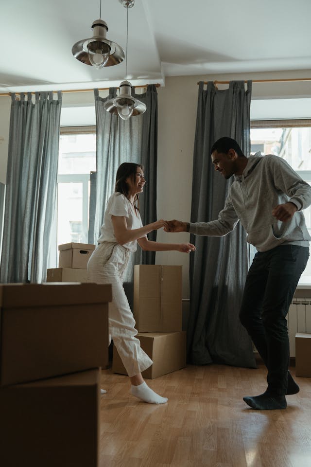 Two people dancing in their new apartment