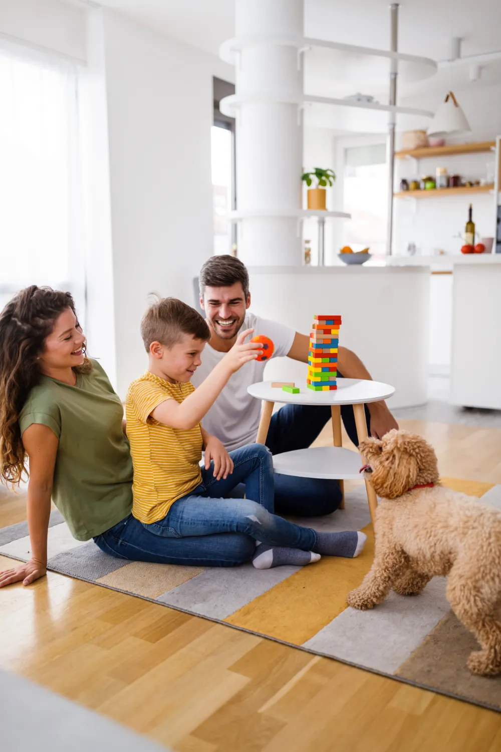 Happy family playing games at a small table in living room