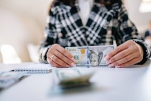 person-counting-money-at-their-desk