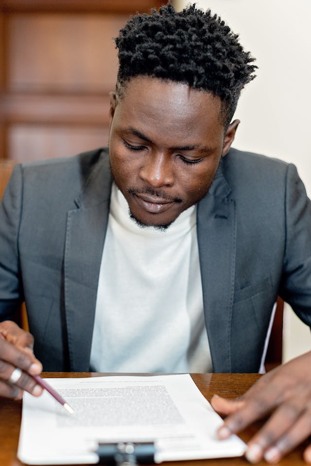 Person sitting at their desk reviewing a contract