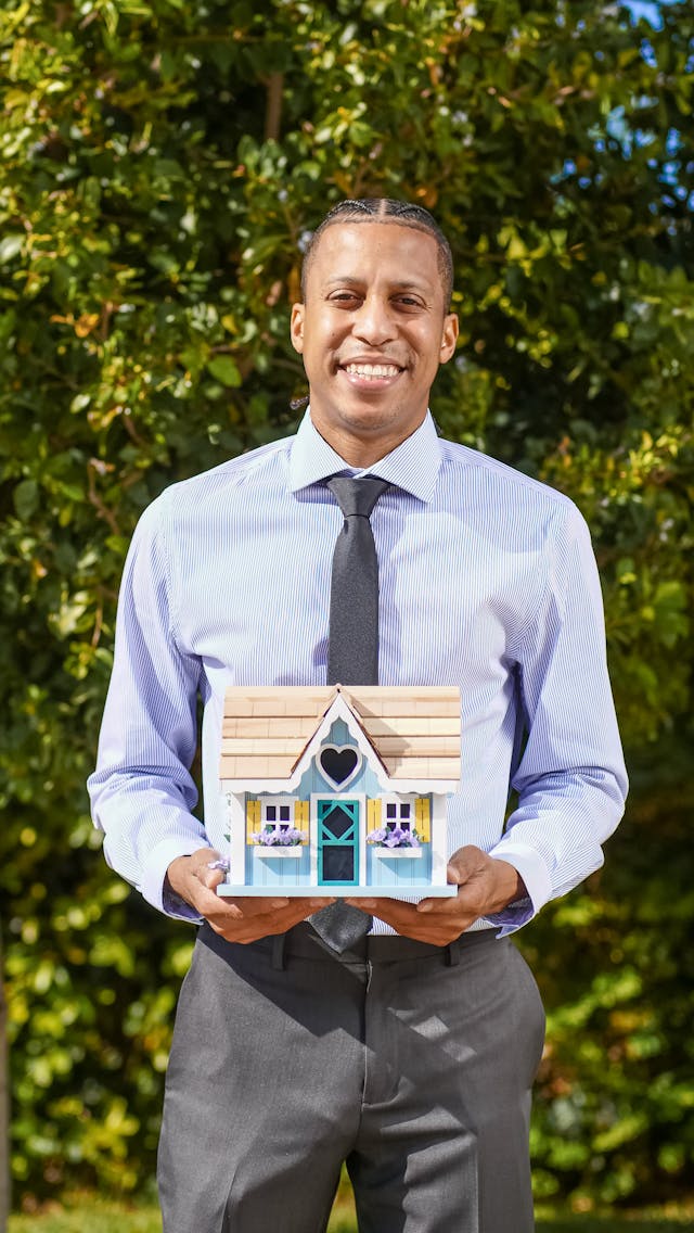 a person holding a home figurine