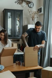 a couple unpacking moving boxes
