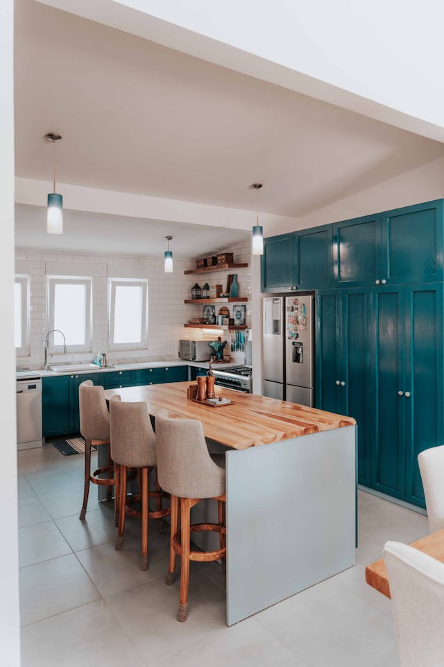 a kitchen with blue cabiets and a white kitchen island