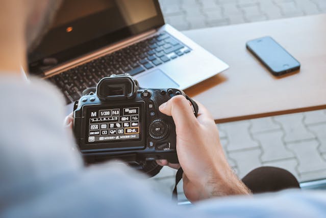 a person adjusting the setting on their camera