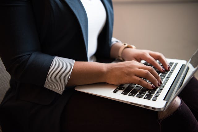 a person typing on a laptop