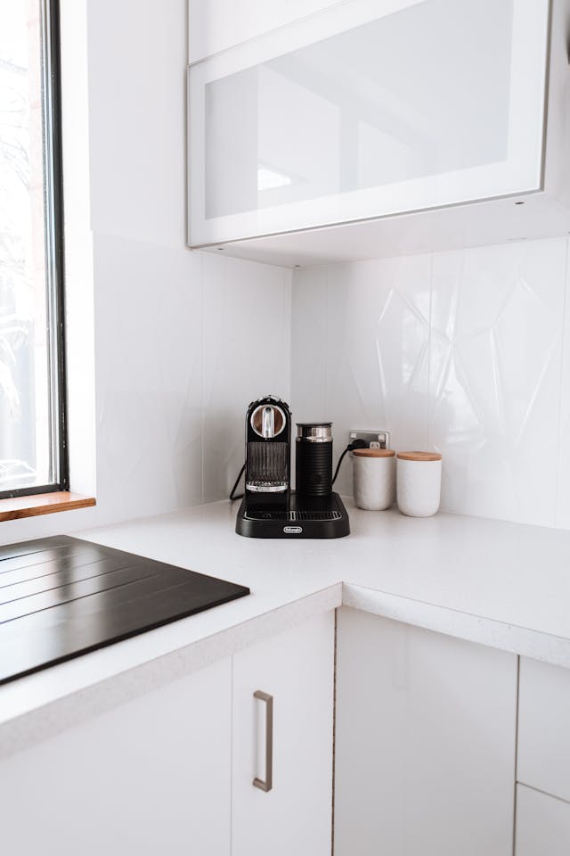 an all white kitchen with modern appliances