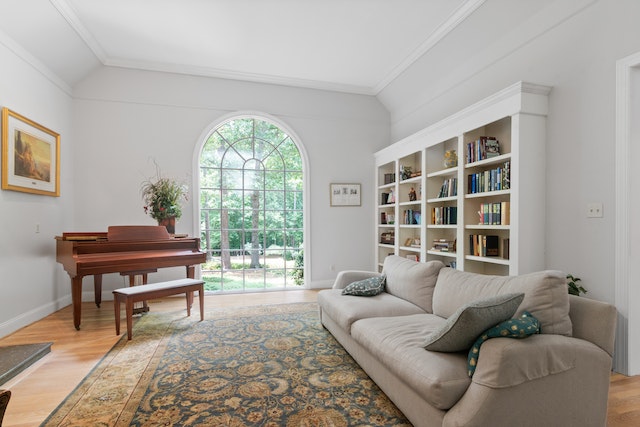 living room with a large picture window, white book case, and a brown piano