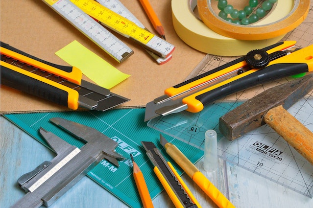 maintenance work station with rulers levels and other tools spread out