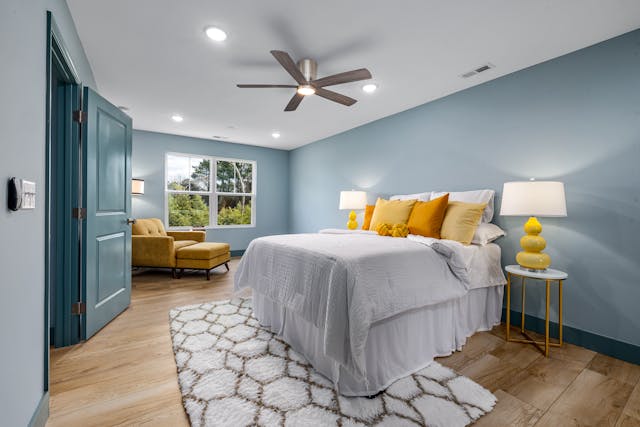 a blue bedroom with a large window