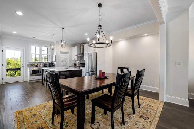 a kitchen and dining area with a large wooden table