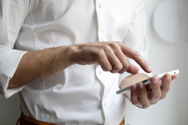 person in white shirt taking a phone call