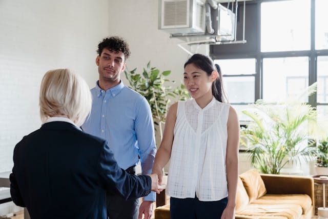 a landlord speaking with two tenants in a rental property